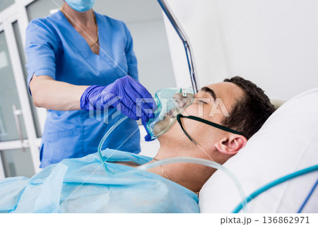 Doctors give resuscitation to a male patient in the emergency room. 136862971