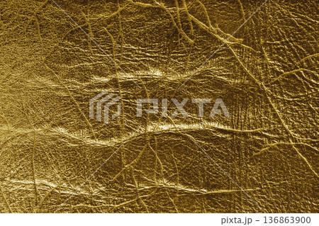 Detailed yellow colored wrinkled textured leather with natural creases texture background 136863900