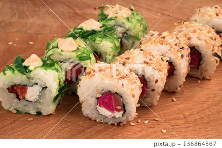 Sushi rolls on a wooden board delicious food 136864367