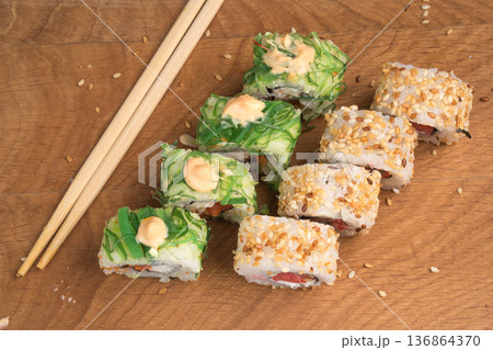 Sushi rolls on a wooden board delicious food Sushi rolls on a wooden board delicious food 136864370