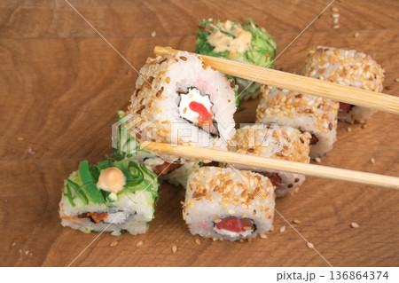 Sushi rolls on a wooden board delicious food Sushi rolls on a wooden board delicious food 136864374