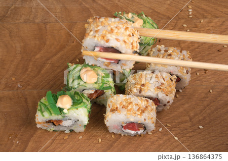Sushi rolls on a wooden board delicious food Sushi rolls on a wooden board delicious food 136864375