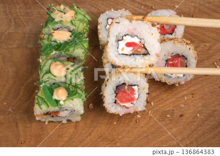 Sushi rolls on a wooden board delicious food Sushi rolls on a wooden board delicious food 136864383