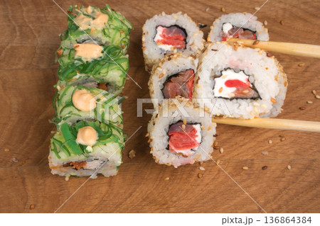 Sushi rolls on a wooden board delicious food Sushi rolls on a wooden board delicious food 136864384