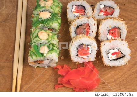Sushi rolls on a wooden board delicious food Sushi rolls on a wooden board delicious food 136864385