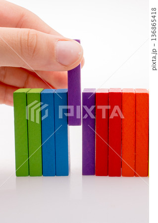 Hand holding color dominoes 136865418