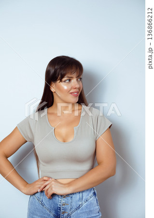 Confident woman posing isolated on neutral studio background Confident woman posing isolated on neutral studio background 136866212