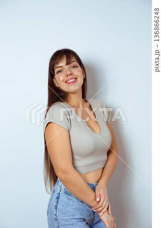 Confident woman posing isolated on neutral studio background 136866248