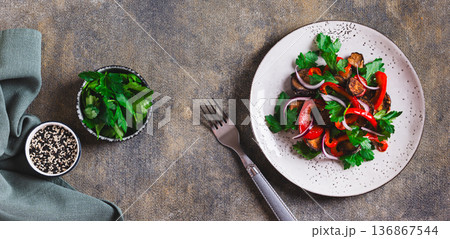 Vegetable vegetarian salad with eggplant, bell pepper and parsley on a plate top view web banner Vegetable vegetarian salad with eggplant, bell pepper and parsley on a plate top view web banner 136867544