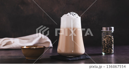 Gourmet drink black sesame latte in a glass on the table web banner Gourmet drink black sesame latte in a glass on the table web banner 136867554