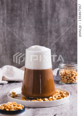 Gourmet peanut raf coffee in a glass on the table vertical view Gourmet peanut raf coffee in a glass on the table vertical view 136867567