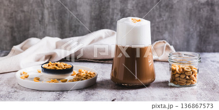Gourmet peanut raf coffee in a glass on the table web banner 136867573
