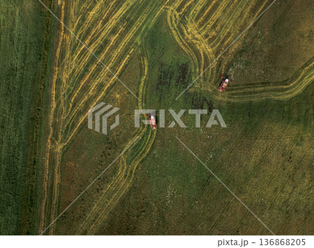 Aerial View of Green Field with Red Tractors in Rural Belarus Aerial View of Green Field with Red Tractors in Rural Belarus 136868205
