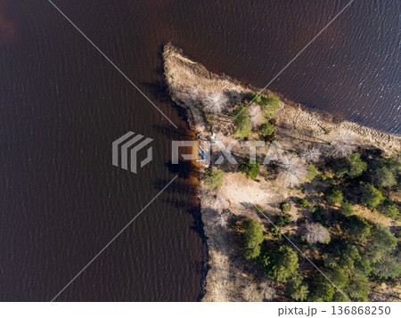 Aerial View of Tree Covered Peninsula Extending into Dark Water Aerial View of Tree Covered Peninsula Extending into Dark Water 136868250