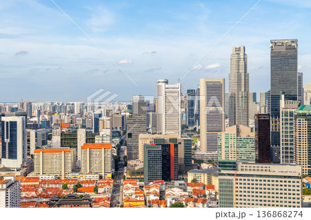 Panoramic skyline of Singapore central business district with dense modern skyscrapers and traditional red residential rooftops Panoramic skyline of Singapore central business district with dense modern skyscrapers and traditional red residential rooftops 136868274