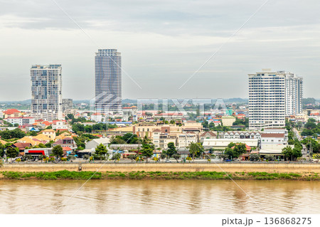 Modern apartment buildings rising above traditional houses along Tonle Sap riverbank in Phnom Penh, Cambodia 136868275