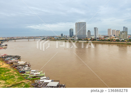 River cruise boats moored along Tonle Sap River with modern skyline in background, Phnom Penh, Cambodia River cruise boats moored along Tonle Sap River with modern skyline in background, Phnom Penh, Cambodia 136868278
