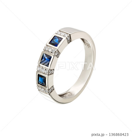 White metal ring with blue square gemstones and pave accents, isolated White metal ring with blue square gemstones and pave accents, isolated 136868423