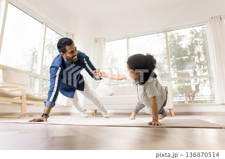 Father and son fist bumping while performing one-armed push-up Father and son fist bumping while performing one-armed push-up 136870514