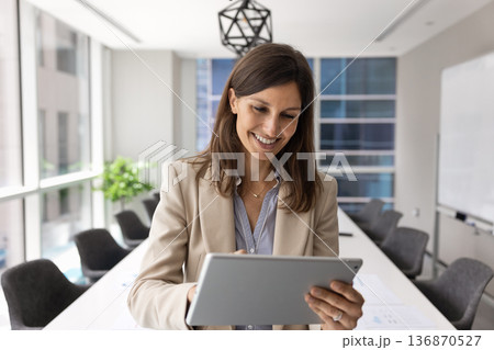 Businesslady, business analyst or corporate trainer working on tablet 136870527