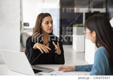 Young Middle Eastern business professional woman talking to consultant 136870567