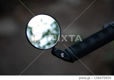 bicycle rear view mirror, attached to the handlebars of the bicycle bicycle rear view mirror, attached to the handlebars of the bicycle 136870950