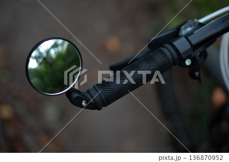 bicycle rear view mirror, attached to the handlebars of the bicycle 136870952
