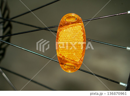 a reflector attached to a bicycle wheel. a reflector attached to a bicycle wheel. 136870961