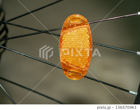a reflector attached to a bicycle wheel. 136870963