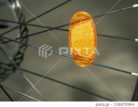 a reflector attached to a bicycle wheel. a reflector attached to a bicycle wheel. 136870964