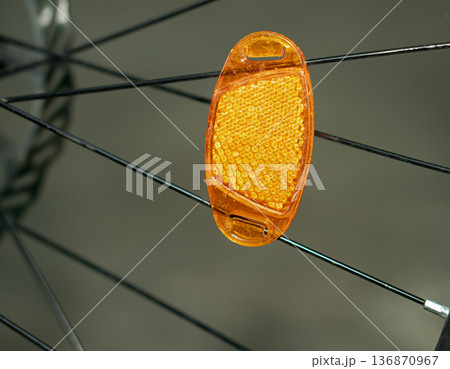 a reflector attached to a bicycle wheel. a reflector attached to a bicycle wheel. 136870967
