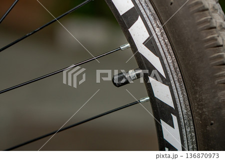 A valve with a cap on a bicycle wheel 136870973