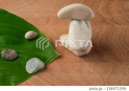 Green Leaves, Wayward Hosts and Stones of Various Velecheny on the Background of a Wooden Board Green Leaves, Wayward Hosts and Stones of Various Velecheny on the Background of a Wooden Board 136871209
