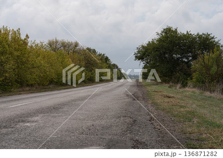 asphalt road with trees on the roadside in autumn asphalt road with trees on the roadside in autumn 136871282