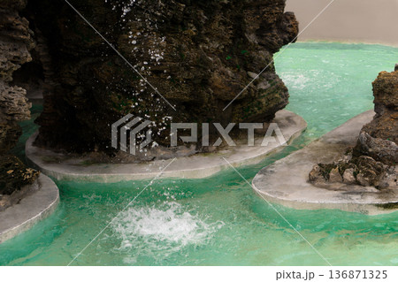 Waterfall, water drop into an artificial reservoir against the background of stones, natural origin Waterfall, water drop into an artificial reservoir against the background of stones, natural origin 136871325