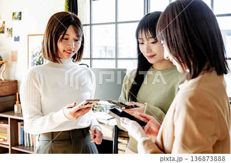スマートフォンを使う3人の女性 136873888