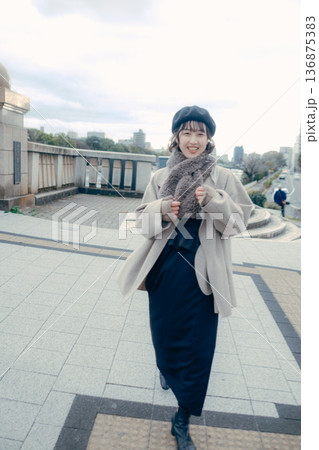 冬の都会を歩く笑顔の30代日本人女性 冬の都会を歩く笑顔の30代日本人女性 136875383