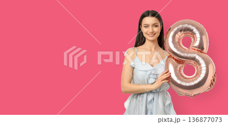 Young woman smiles with an 8-shaped balloon Young woman smiles with an 8-shaped balloon 136877073