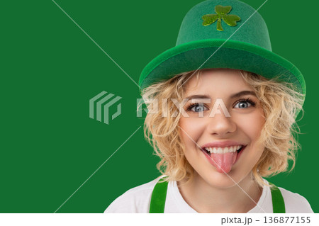 A woman in a green hat shows her tongue in celebration 136877155