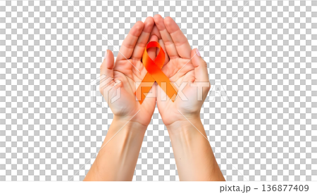 Hands clasping an orange ribbon on a transparent backdrop, highlighting support for leukemia awareness and blood cancer initiatives 136877409