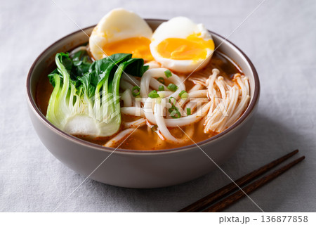 Spicy Udon Noodle Soup topped with Bok Choy, Enoki Mushrooms and Soft Boiled Egg 136877858