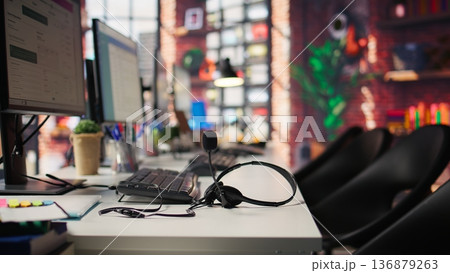 Multiple computer monitors in empty office displaying analytics dashboards and data charts. Office workspace with screens showing digital data visualization and operational management Multiple computer monitors in empty office displaying analytics dashboards and data charts. Office workspace with screens showing digital data visualization and operational management 136879263