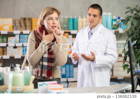 Girl pharmacy client suffers from sore throat and cold, pharmacist want to help Girl pharmacy client suffers from sore throat and cold, pharmacist want to help 136882130