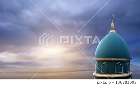 A beautiful teal mosque dome with a golden crescent moon sits against a dramatic cloudy sunset sky over a vast desert landscape. Perfect copy space for Ramadan, Eid Mubarak, and religious designs A beautiful teal mosque dome with a golden crescent moon sits against a dramatic cloudy sunset sky over a vast desert landscape. Perfect copy space for Ramadan, Eid Mubarak, and religious designs 136883008
