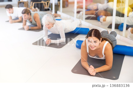 Young woman practicing pilates with roller in gym room Young woman practicing pilates with roller in gym room 136883136