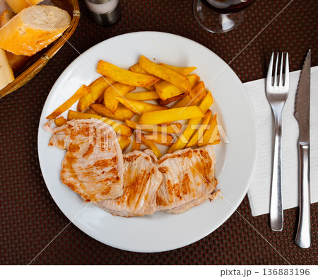 Pork loin served with potatoes on platter Pork loin served with potatoes on platter 136883196