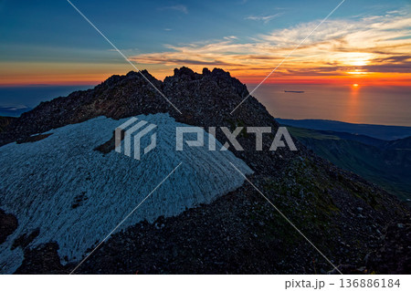 鳥海山外輪山・七高山から見る日本海に沈む夕日と新山山頂 鳥海山外輪山・七高山から見る日本海に沈む夕日と新山山頂 136886184