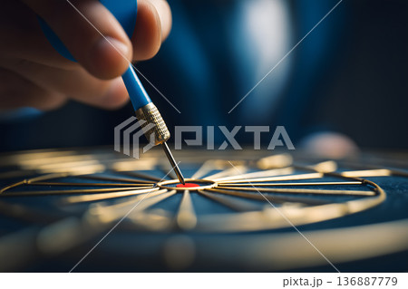 Person is holding a blue dart and is about to throw it Person is holding a blue dart and is about to throw it 136887779