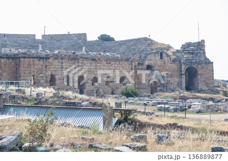 Ancient Ruins of Pamukkale Reveal History and Architecture of a Bygone Era Under Clear Sky and Warm Sunlight 136889877
