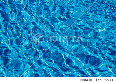Bright Blue Water Reflecting Sunlight Creates a Serene Atmosphere in a Swimming Pool During a Sunny Afternoon Bright Blue Water Reflecting Sunlight Creates a Serene Atmosphere in a Swimming Pool During a Sunny Afternoon 136889934